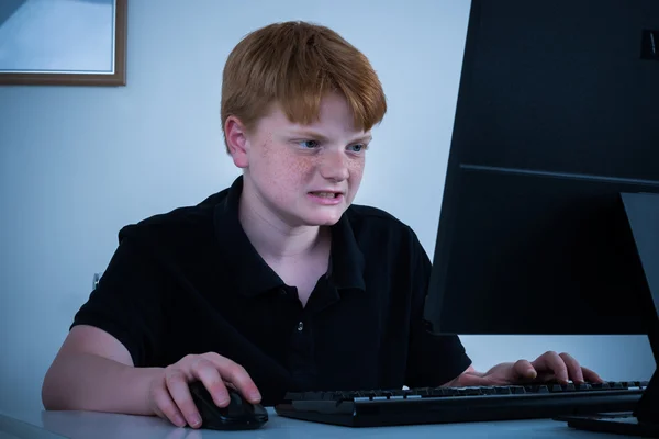 Angry Boy Working On Computer