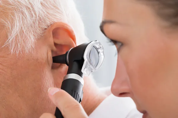 Female Doctor Examining Patient\'s Ear
