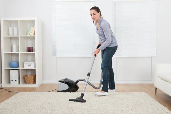 Woman Vacuuming Rug
