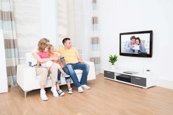 Young Family Watching TV Together