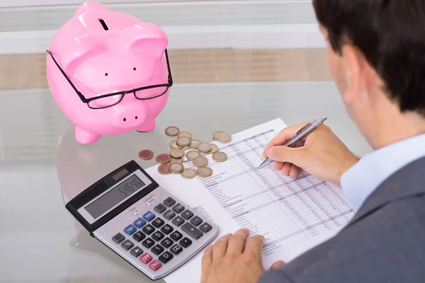Man calculating savings and costs