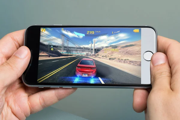 Hands Playing Asphalt 8 Game On Apple iPhone 6