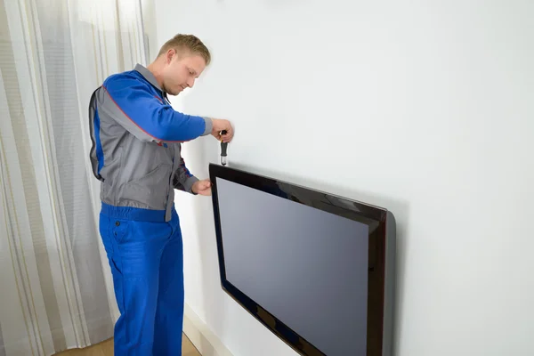 Technician Repairing Television