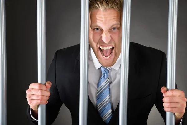 Aggressive Businessman Behind Bars