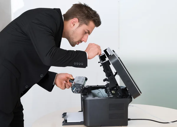 Businessman Fixing Cartridge In Photocopy Machine