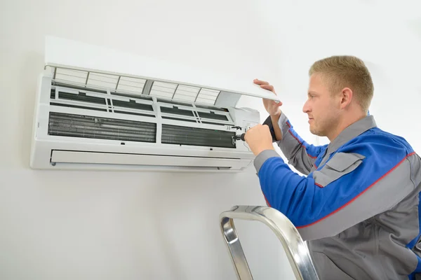 Technician Repairing Air Conditioner