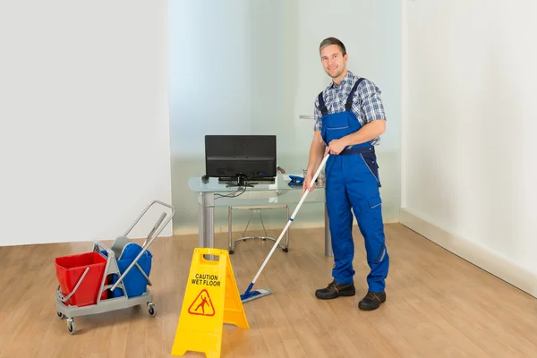 Man Cleaning Office Floor