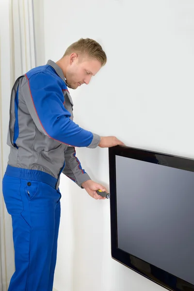 Technician Repairing Television