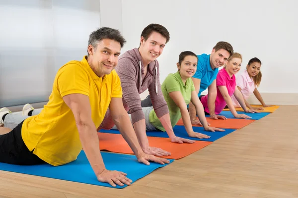 People Exercising On Mats