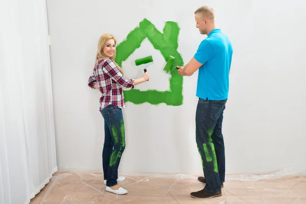Couple Painting House On Wall