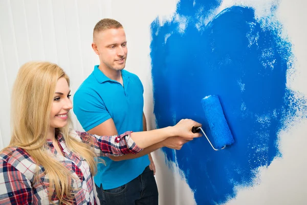 Young Couple Painting Wall