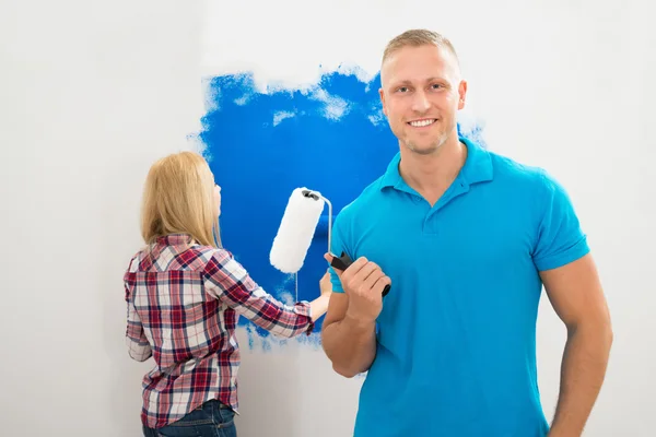 Man Holding Paint Roller