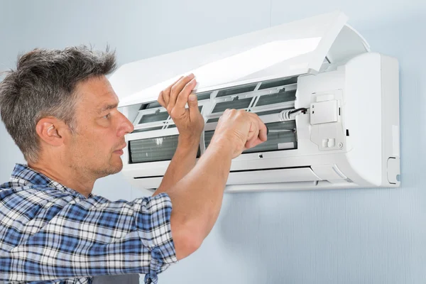 Technician Repairing Air Conditioner