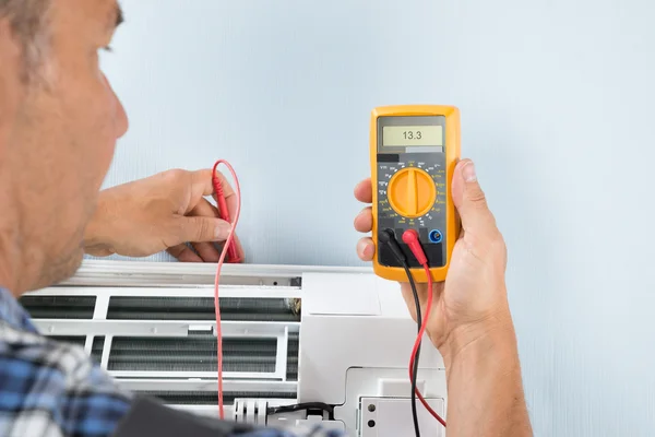 Technician Testing Air Conditioner