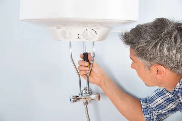 Plumber Repairing Water Heater