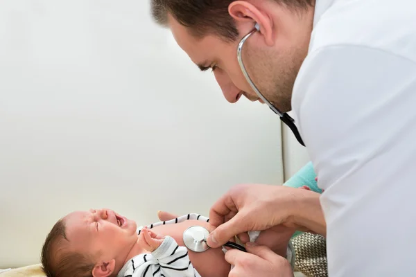 Doctor Examining Crying Baby