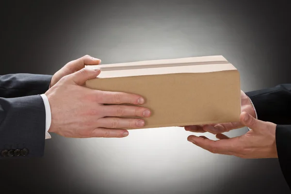 Businessman Giving Box