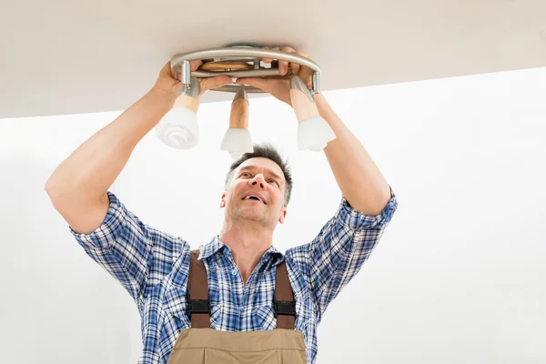 Technician Fixing Light