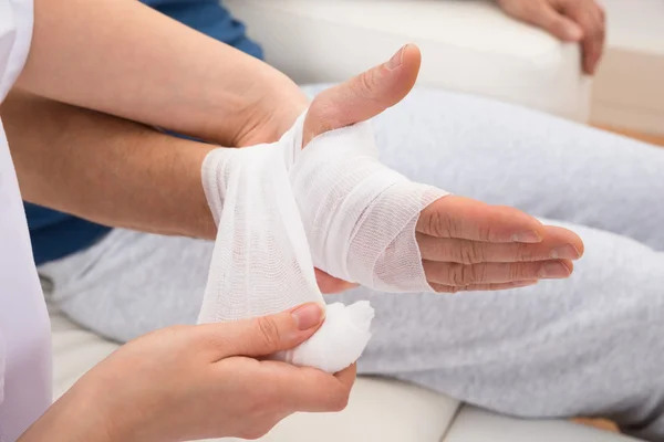 Bandaging Patient Hand