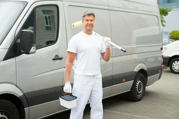Painter Standing In Front Of Van