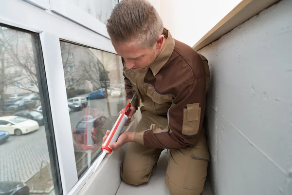 Man Applying Silicone Sealant