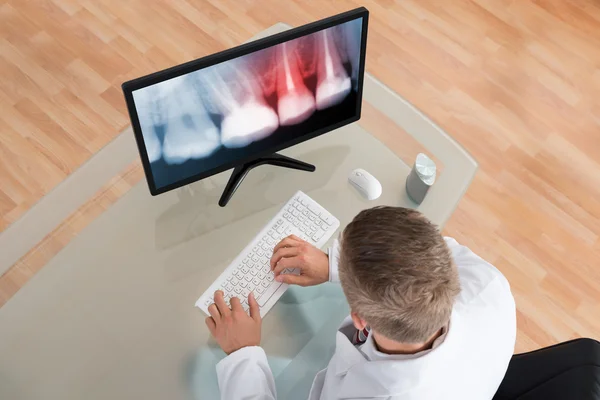 Dentist Looking At X-ray On Computer