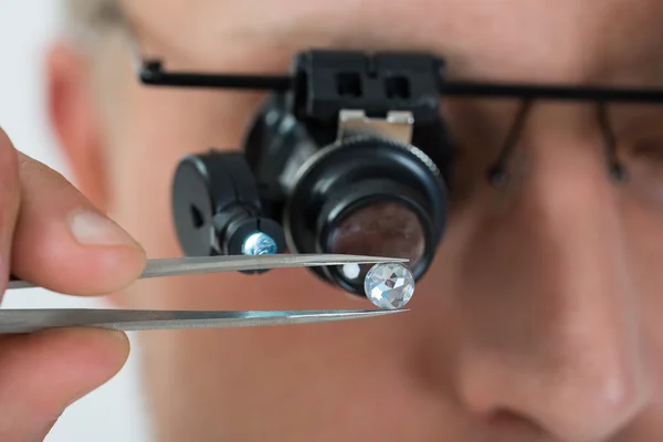 Person Looking At Diamond With  Loupe
