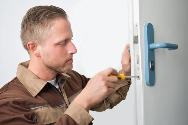 Carpenter Repairing Door Lock