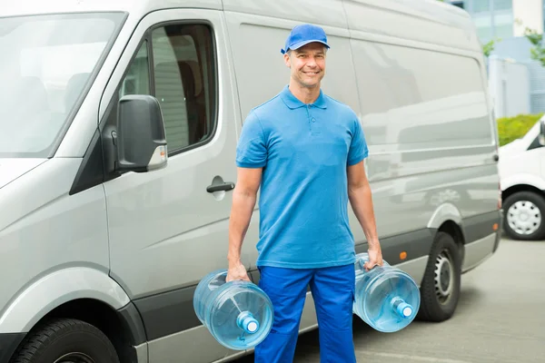 Delivery Man With Two Large Water Bottles