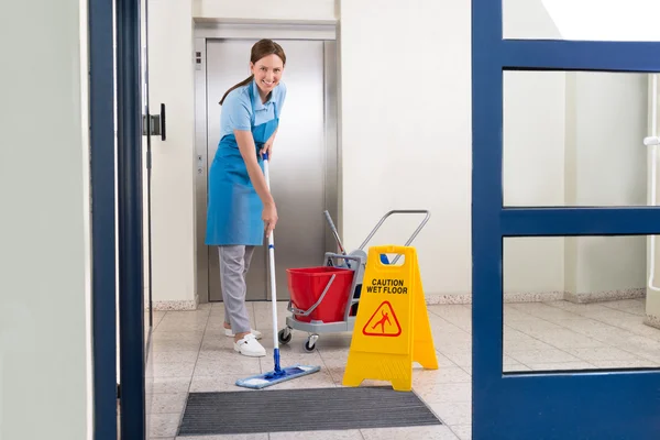 Worker Cleaning Floor With Mop