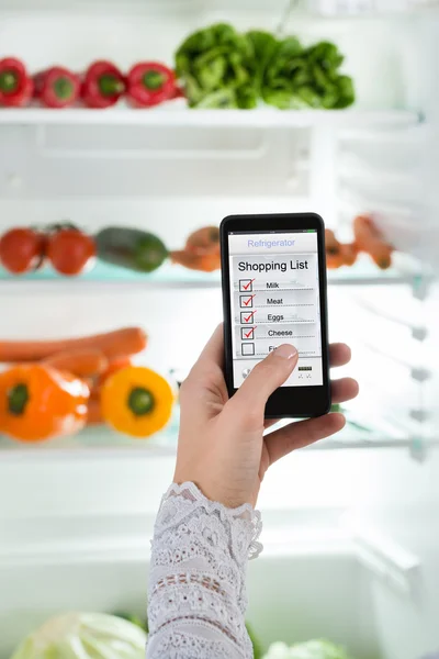 Person Hand With Mobile Phone Showing Shopping List