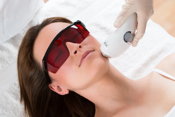 Woman Receiving Laser Epilation Treatment