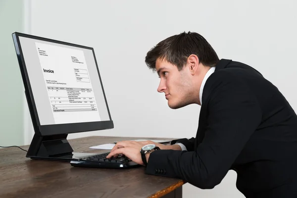 Businessman Looking At Invoice