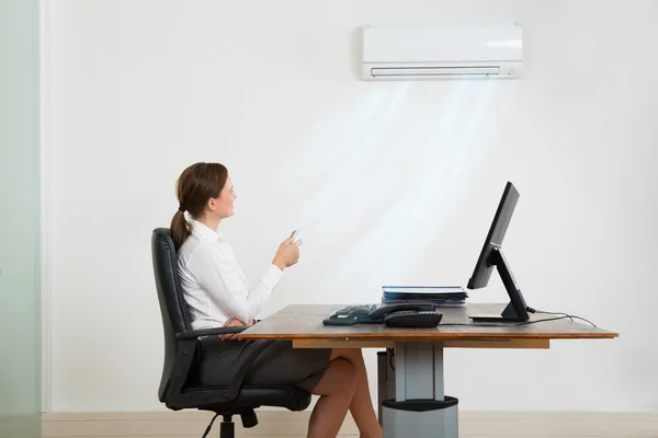 Businesswoman Using Air Conditioner