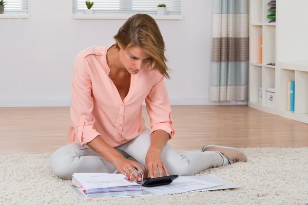 Woman Calculating Invoices With Calculator