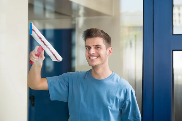 Worker Cleaning Glass With Mop