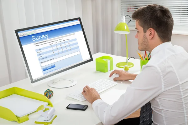 Businessman Filling Online Survey Form On Computer