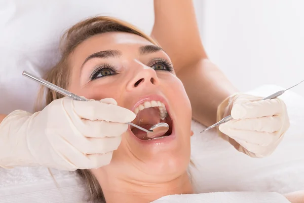 Woman Getting Checkup At Dentist\'s Office