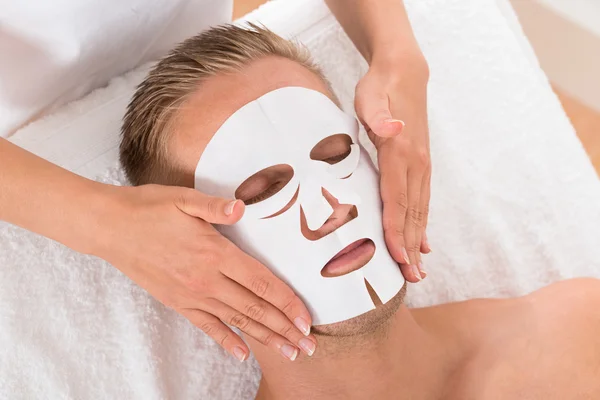 Man In Spa Salon With Facial Mask