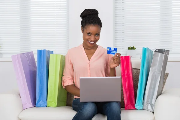 Woman Using Debit Card For Shopping