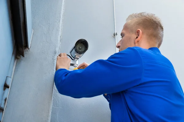 Technician Installing Camera In Corner