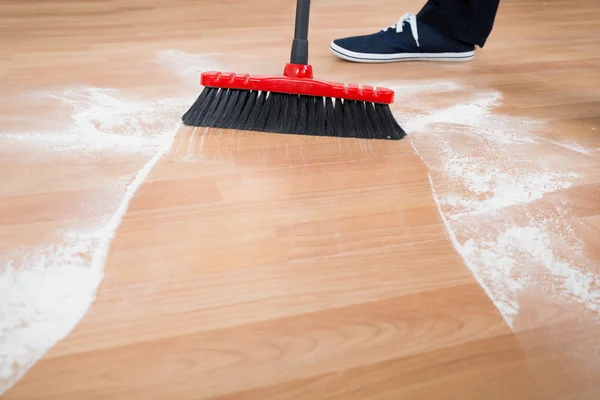 Man Sweeping Hardwood Floor