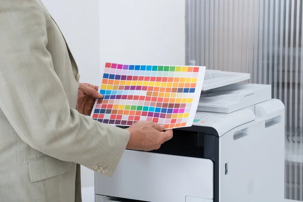 Businessman Holding Multi Colored Paper