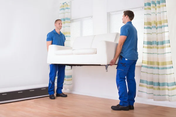 Movers Carrying Sofa At Home