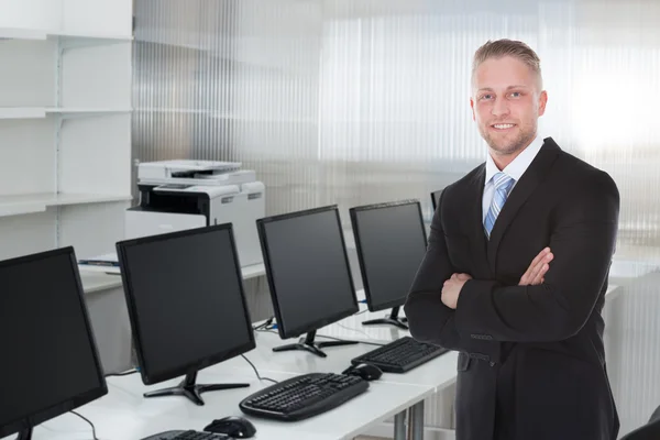 Young Businessman Standing Arms Crossed