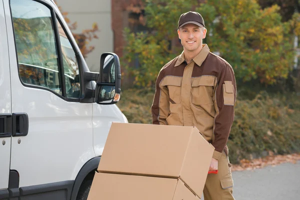 Confident Delivery Man Pushing Parcels