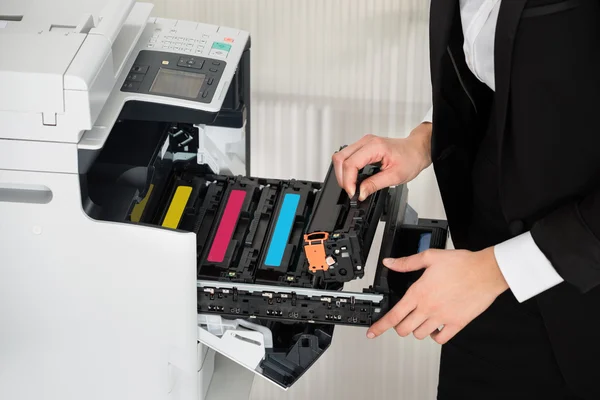 Businessman Fixing Cartridge In Printer Machine