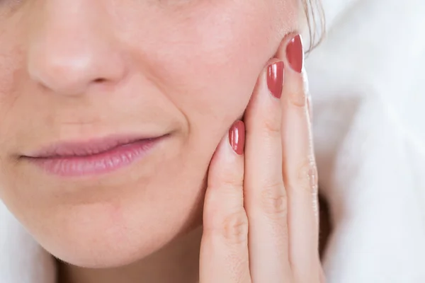 Woman With A Toothache Touching Face