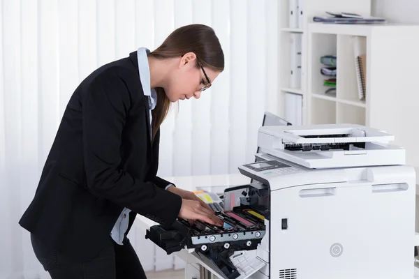 Businesswoman Fixing Copy Machine