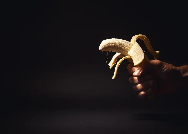 Male Hand Holding a Banana